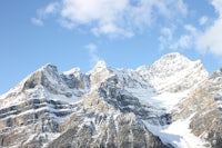 a snow covered mountain with a blue sky